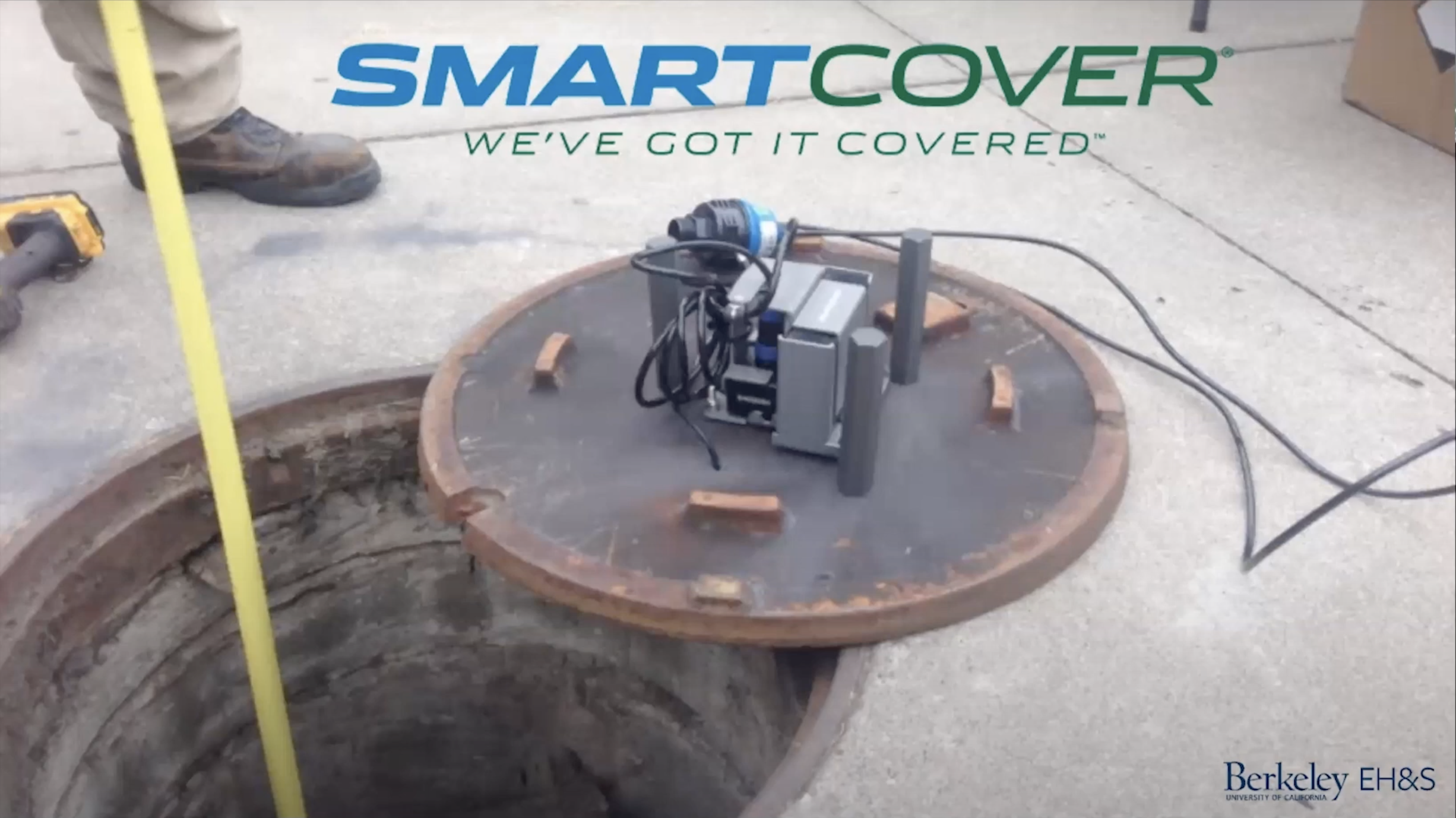 picture of a sewer cover with electronics attached to it