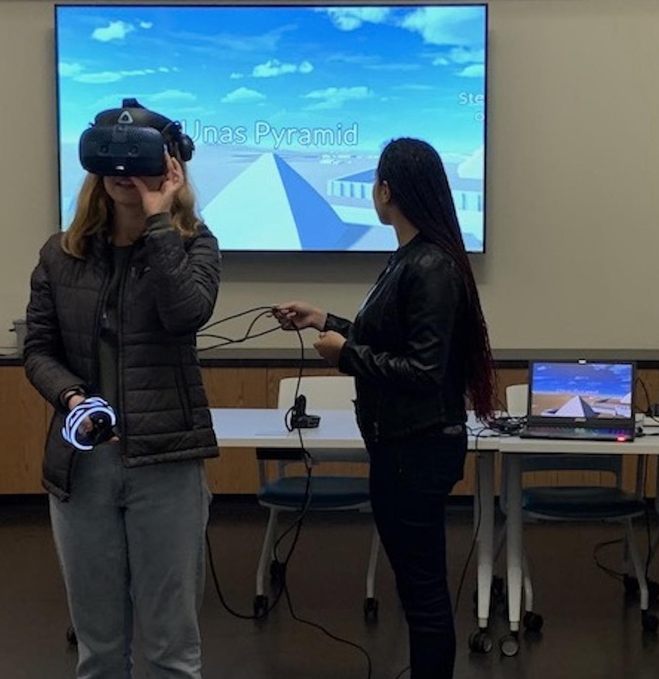 Two women testing out virtual reality equipment