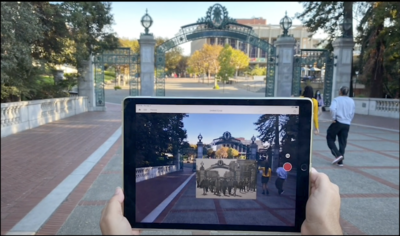 Photo of campus building with augmented reality images floating in front of it